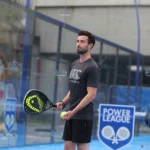 Man getting ready to serve whilst playing padel