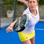 Female padel player returns the ball