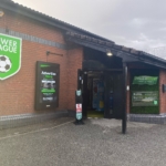 Entrance to a sports complex with a sign reading 